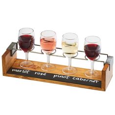 four glasses of wine on a wooden stand