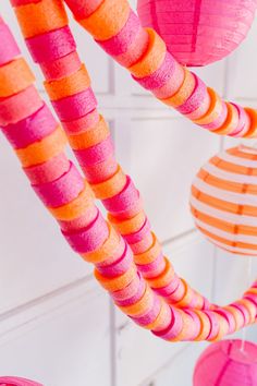 pink and orange paper lanterns hanging from the ceiling