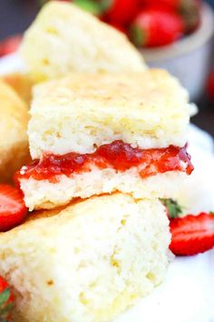 strawberry shortcakes stacked on top of each other with strawberries in the background