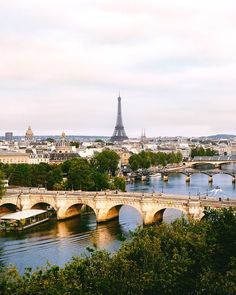 the eiffel tower towering over the city of paris, from across the river