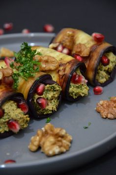 an assortment of food on a plate with garnishes and nuts around it