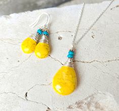 "This beautiful yellow and turquoise necklace and earring set will add a pop of color to any outfit.  A great addition to your spring, summer or fall wardrobe.  I generously wire wrapped each yellow howlite briolette shaped stone with non-tarnish sterling silver wire and added a tiny turquoise stone.  The earrings measure just over 1  1/2\" in length from the top of the sterling silver earwires.  The pendant is slightly larger than the earrings measuring 1 3/4\" in length and 3/4\" in width. The Handmade Vibrant Yellow Jewelry, Vibrant Handmade Yellow Jewelry, Vibrant Yellow Handmade Jewelry, Vibrant Yellow Dangle Earrings, Turquoise Jewelry Set, Yellow And Turquoise, Yellow Necklace, Yellow Jewelry, Beaded Boxes