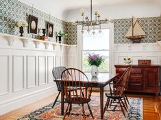 a dining room table with chairs and a rug