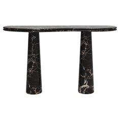 a black marble table with two columns on each side and one column at the end