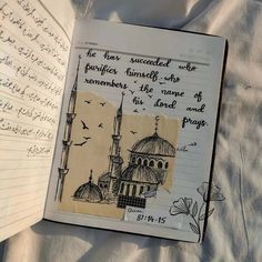 an open notebook with writing on it and a drawing of a mosque in the middle