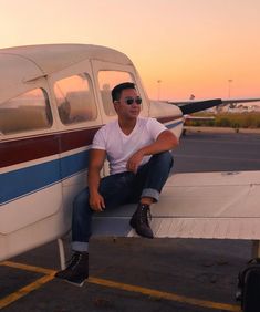 a man sitting on the wing of an airplane