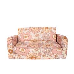 a pink and orange flowered couch sitting on top of a white floor