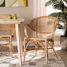 two wicker chairs sitting next to each other in front of a table with lemons on it