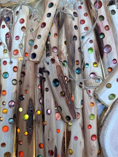 several pieces of wood with colored glass beads on them