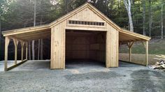 a large wooden garage sitting in the middle of a forest