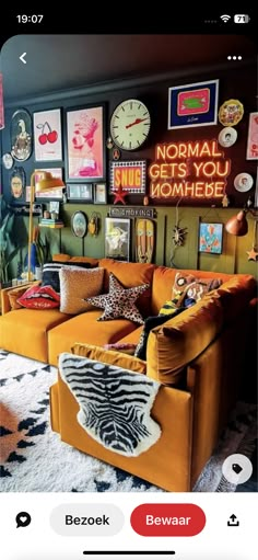 a living room filled with yellow couches and pictures on the wall next to a clock