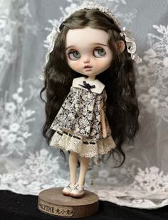 a doll with long hair wearing a dress