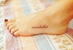 a woman's foot with a small tattoo that reads, rendelist on it