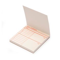 a notepad with an orange line on it is opened to show the inside pages