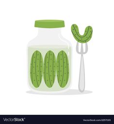 a jar filled with cucumbers next to a spoon