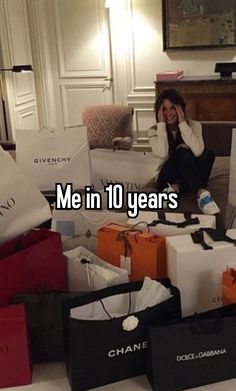 a woman is sitting on the floor surrounded by bags and boxes that say me in 10 years