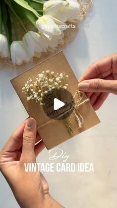 two hands holding a card with flowers on it and the words vintage card idea written below