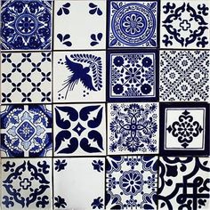 blue and white tiles with designs on them