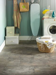 a laundry room with an ironing board and dryer next to the washer