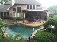 a backyard with a pool and covered patio