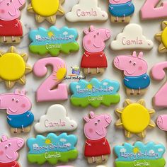 decorated cookies with peppa the pig and other characters are displayed on a white surface