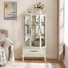 a living room with a chair and a white cabinet in it's corner area