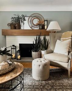 a living room filled with furniture and a fire place next to a wall mounted fireplace