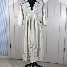 A Statement Dress For The Bride, Wedding Guest, Or Other Very Special Occasion. 100% Silk Ivory Kimono Style With Appliqu Flowers And Eyeleting On Bodice, Sleeves, Front Skirt, And Hem All Around. Slips Over Your Head With A Single Covered Button At Back Waist And Ribbon Tie At Neck. Elegant Detailing Of Tiny Pleats Under Bust And At Waist In Back. Size Small And Length Shoulder-To-Hem Is 40 Inches. Nwt. Spring Empire Waist Wedding Dress, Elegant Lace Midi Dress For Wedding, Elegant Lace Work Midi Dress For Wedding, Elegant Empire Waist Dress For Wedding Night, Cream Lace Trim Midi Dress For Wedding, Cream Lace Midi Dress For Wedding, Spring Wedding Empire Waist Midi Dress, Spring Wedding Midi Dress With Empire Waist, Silk Beige Midi Dress For Wedding