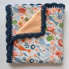 a blue and orange blanket with a bird design on it