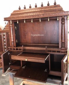 an old wooden desk with drawers on it's sides in a store display area