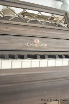 an old piano is sitting in front of a window with the words welcome home on it