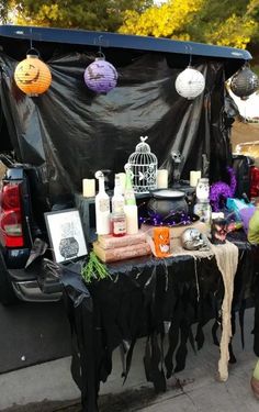 a table with candles and decorations on it next to a parked car in the street