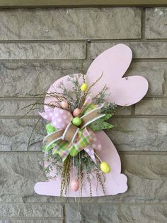 a pink bunny door hanger with eggs and greenery