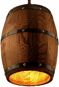 a wooden barrel light hanging from a ceiling fixture with metal straps on the bottom and sides