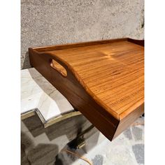 a wooden tray sitting on top of a stone floor