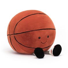 a basketball stuffed animal with a pair of scissors in front of it's face