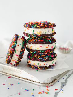 three ice cream sandwiches stacked on top of each other with sprinkles