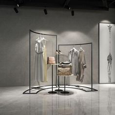 an empty room with clothes on display in it