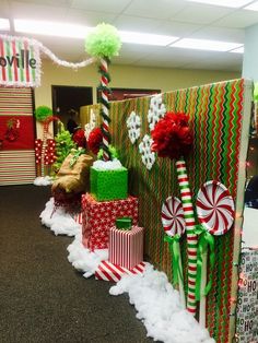 christmas decorations in an office cubicle decorated with candy canes, presents and gifts