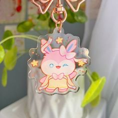 a keychain with an image of a bunny in the center and stars on it