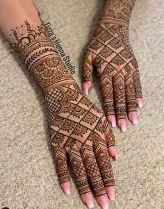 two hands with henna tattoos on them