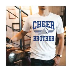 a man wearing a white shirt with the words cheer brother on it and a megaphone in his hand