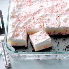 a cake with white frosting and red sprinkles