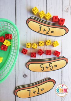 some legos are laying on the floor next to a basket with numbers in them