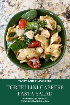 tortellini caprese pasta with spinach and tomatoes in a green bowl