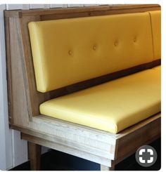 a close up of a yellow bench with buttons on it's armrests