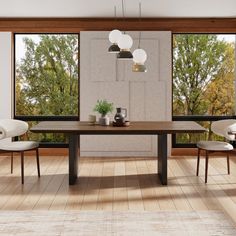 a dining room table and chairs in front of large windows