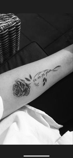 a woman's arm with roses on it and the word love written in cursive writing