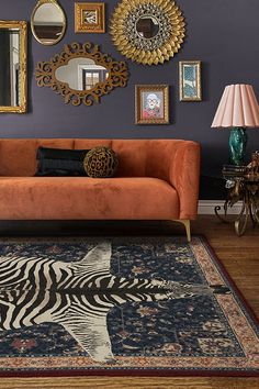 a living room filled with furniture and pictures on the wall