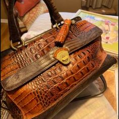 I Received This Bag As A Gift. I Carried It About 5 Times. This Bag Looks Exactly Brand New. The Tassel In The Bag Still Has The Band On It. It’s A Beautiful Piece And The Style Has Been Retired. It Is Truly A Beautiful Brahmin Bag In A Classic Elegant Style. Designer Brown Shoulder Bag With Crocodile Pattern, Designer Brown Crocodile Pattern Shoulder Bag, Designer Brown Bag With Crocodile Pattern, Luxury Italian Brown Shoulder Bag, Lv Pochette Metis, Brahmin Purses, Classic Elegant Style, Lv Pochette, Brown Tote Bag